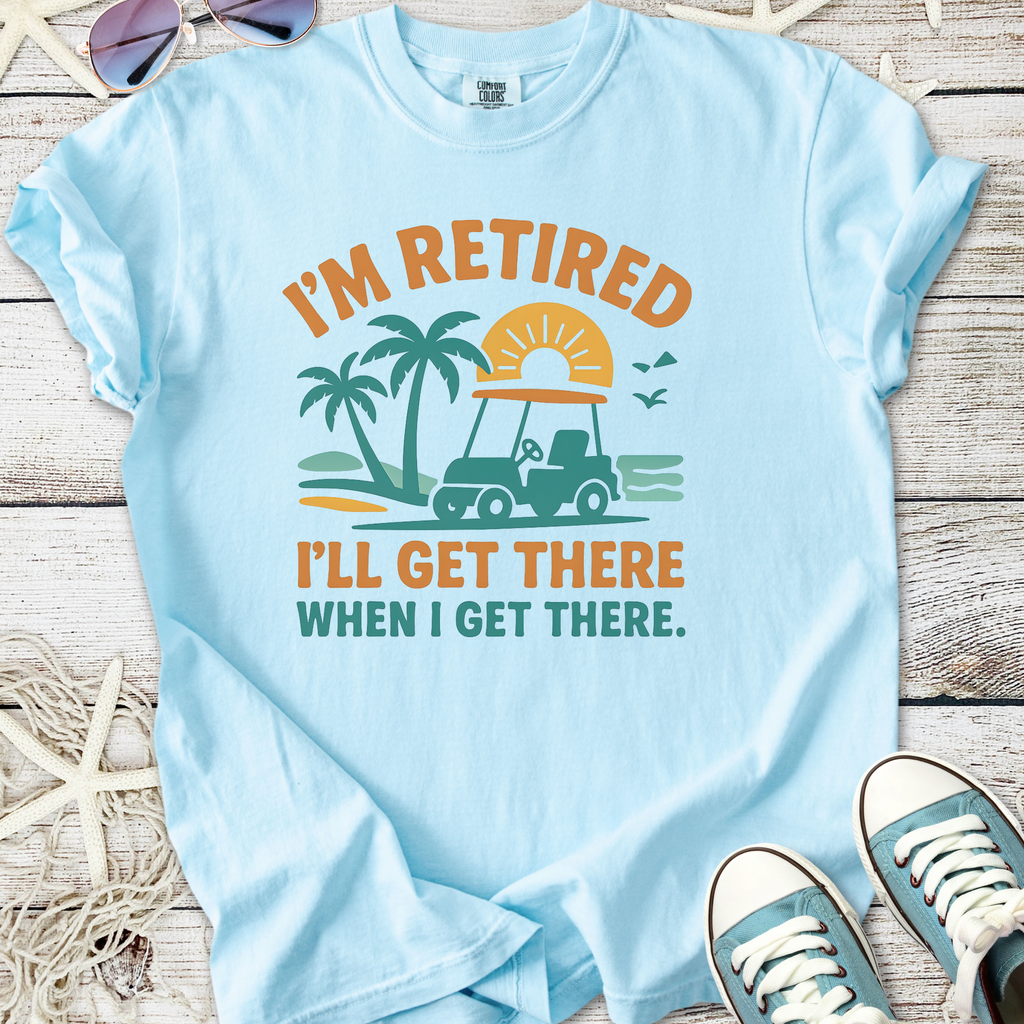 Light blue cotton t-shirt with fun retired golf cart graphic and text, perfect for casual wear.