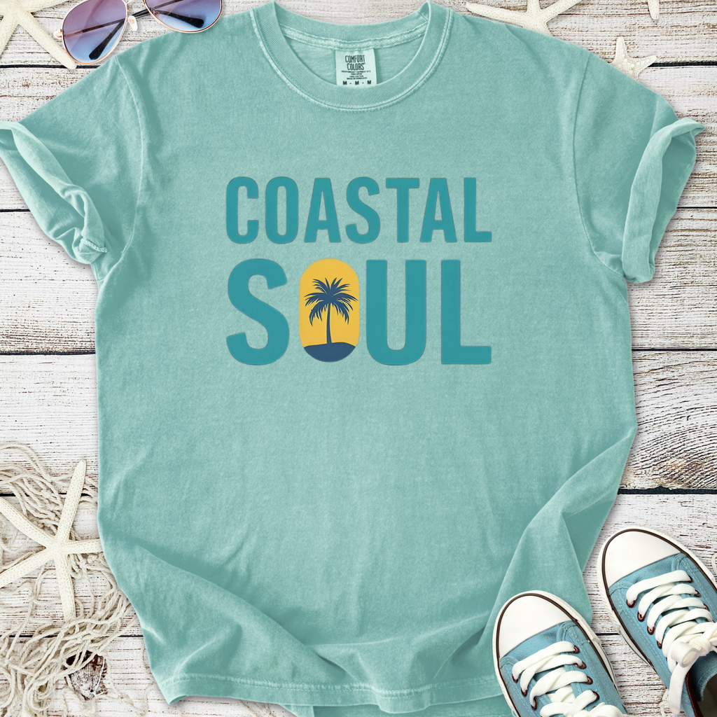 Mint green t-shirt with 'Coastal Soul' graphic and palm tree design, made from soft, comfortable material.