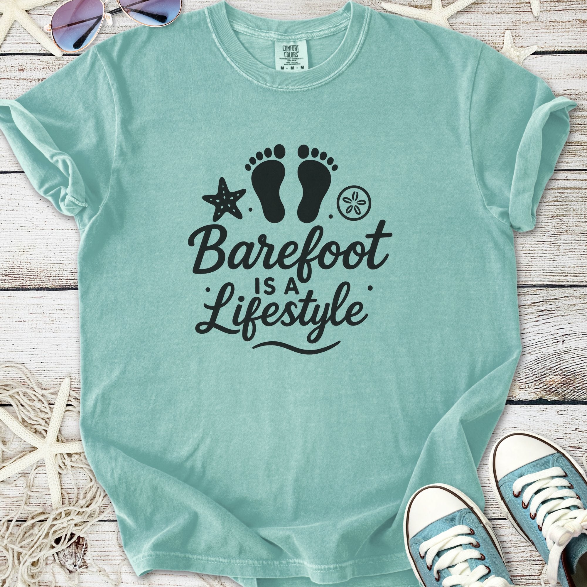 Mint green t-shirt with 'Barefoot is a Lifestyle' graphic, perfect for casual beachwear.