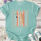 Light blue graphic t-shirt featuring a lounging golden retriever design on a striped background.