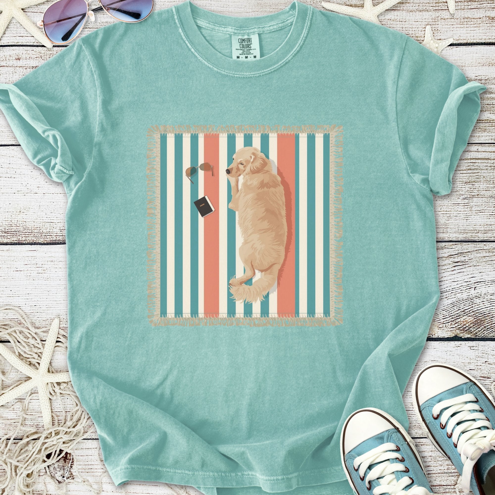 Light blue graphic t-shirt featuring a lounging golden retriever design on a striped background.