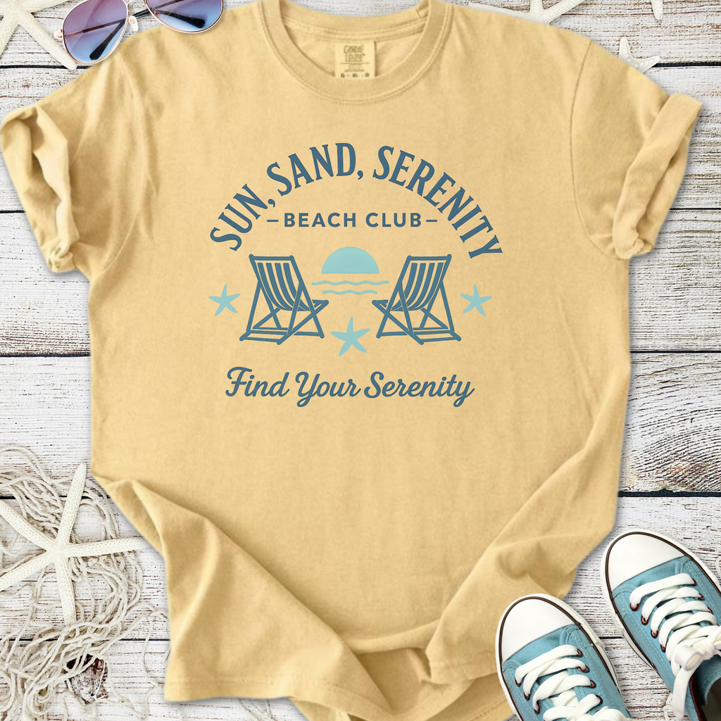 Beige unisex t-shirt with 'Sun, Sand, Serenity Beach Club' graphic, perfect for beach lovers.