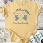 Beige unisex t-shirt with 'Sun, Sand, Serenity Beach Club' graphic, perfect for beach lovers.