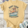 Yellow cotton t-shirt featuring a dog in sunglasses on a boat with 'Boat Hair Don’t Care' graphic.