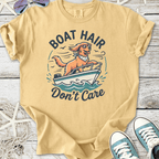 Yellow cotton t-shirt featuring a dog in sunglasses on a boat with 'Boat Hair Don’t Care' graphic.