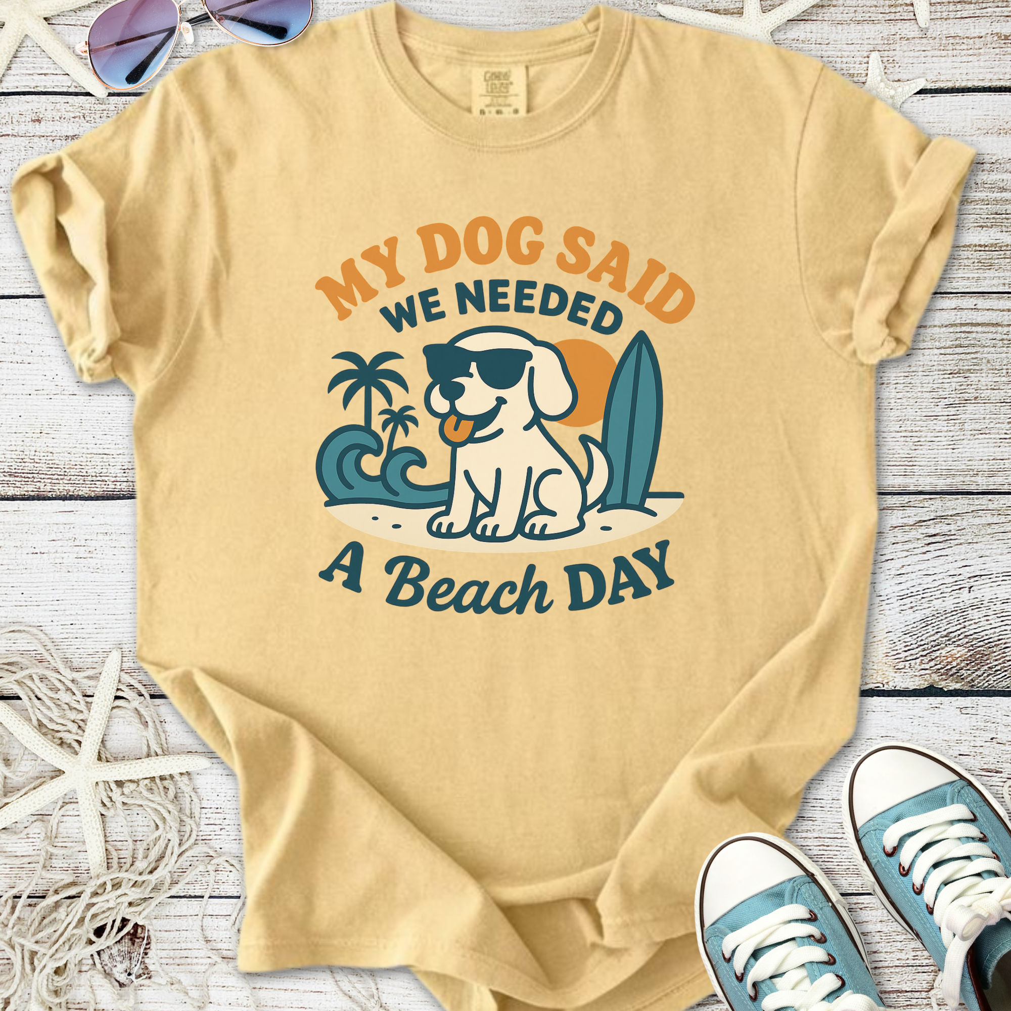 Beige t-shirt with 'My Dog Said We Needed A Beach Day' graphic, featuring a dog in sunglasses and beach theme.