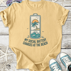 Yellow cotton t-shirt with beach-themed graphic, 'My Social Battery Charges at the Beach' design.