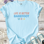 Light blue t-shirt with 'Life is Better Barefoot' graphic, made from soft cotton, perfect for casual wear.