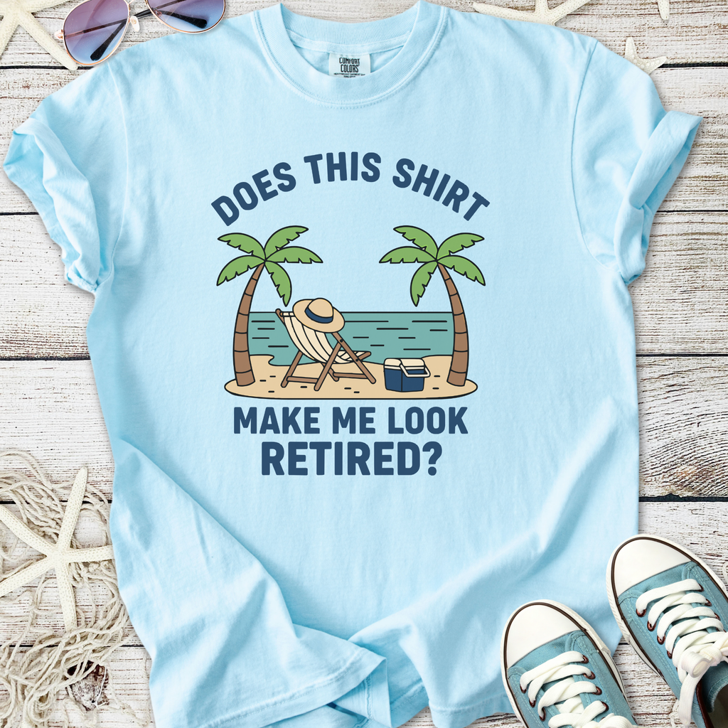 Light blue t-shirt with humorous beach-themed print, featuring palm trees and text 'Does this shirt make me look retired?'