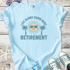 Light blue cotton t-shirt with 'Life Slows Down Here Retirement' graphic and palm trees design.