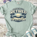 Mint green t-shirt with 'Officially Retired' graphic and beach theme, perfect for relaxed casual wear.