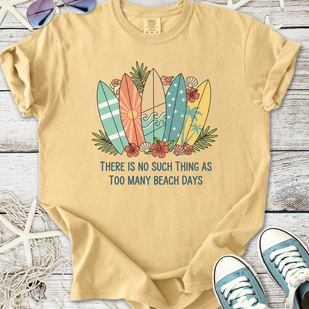 Light beige t-shirt with colorful surfboards design and 'Too Many Beach Days' text, perfect for summer.
