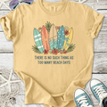 Light beige t-shirt with colorful surfboards design and 'Too Many Beach Days' text, perfect for summer.