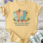 Light beige t-shirt with colorful surfboards design and 'Too Many Beach Days' text, perfect for summer.