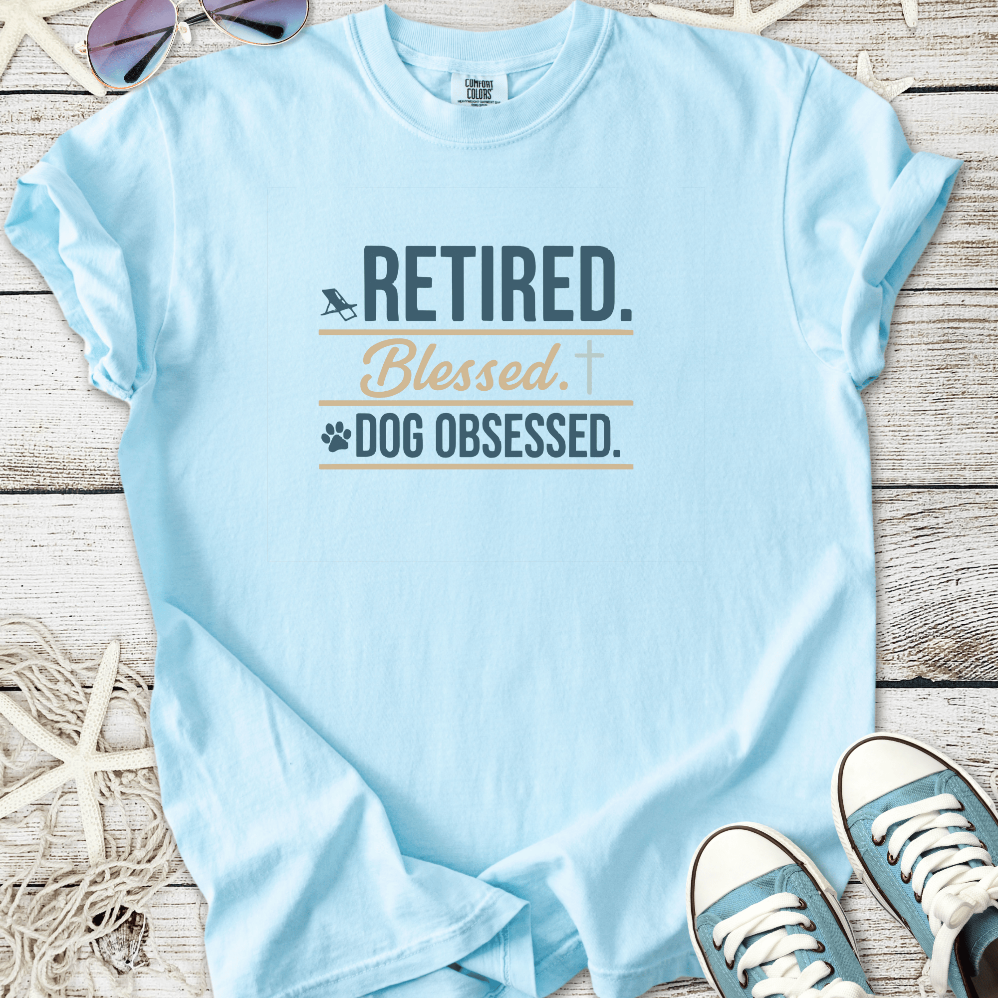 Light blue t-shirt with 'Retired. Blessed. Dog Obsessed.' graphic printed on it.