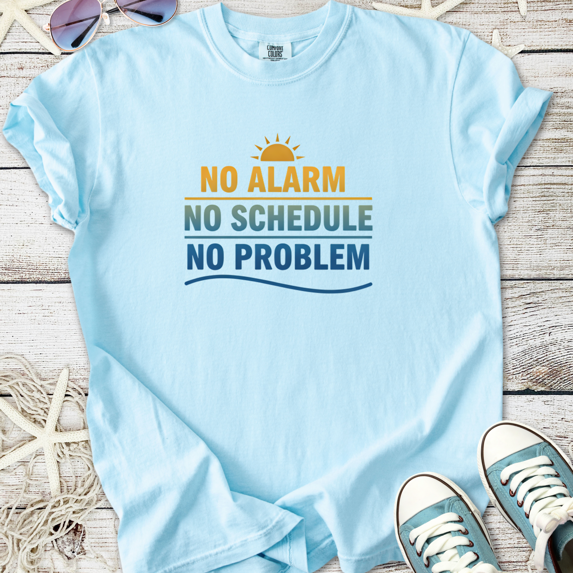 Light blue t-shirt with sunny design and playful text: 'No Alarm No Schedule No Problem'.