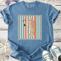 Light blue t-shirt featuring a sleeping golden retriever design on striped background, made of soft cotton.