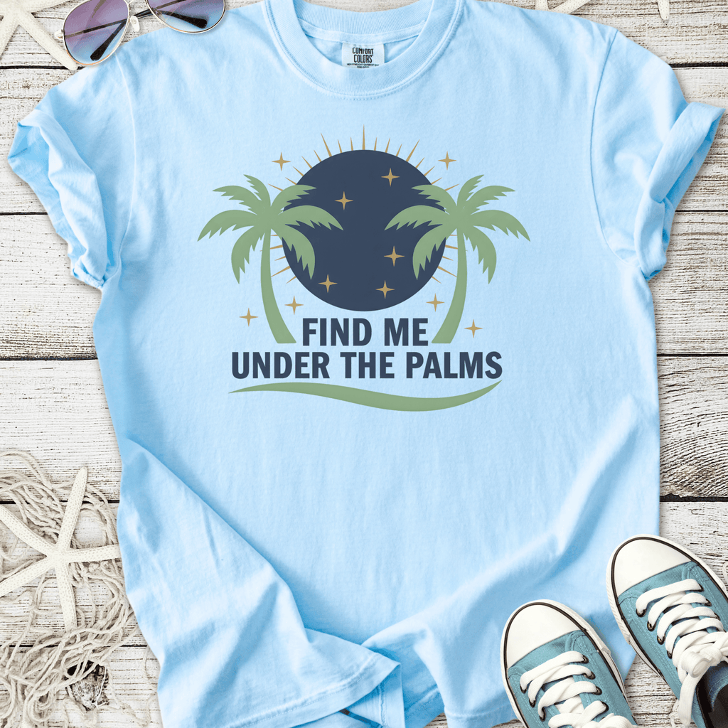 Light blue t-shirt with palm tree design and 'Find Me Under the Palms' text, perfect for summer wear.