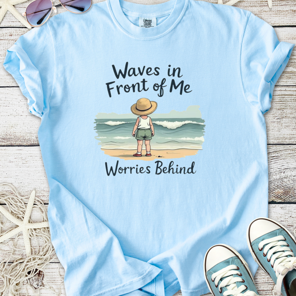 Light blue t-shirt with 'Waves in Front of Me, Worries Behind' graphic, perfect for beach lovers.
