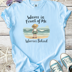 Light blue t-shirt with 'Waves in Front of Me, Worries Behind' graphic, perfect for beach lovers.