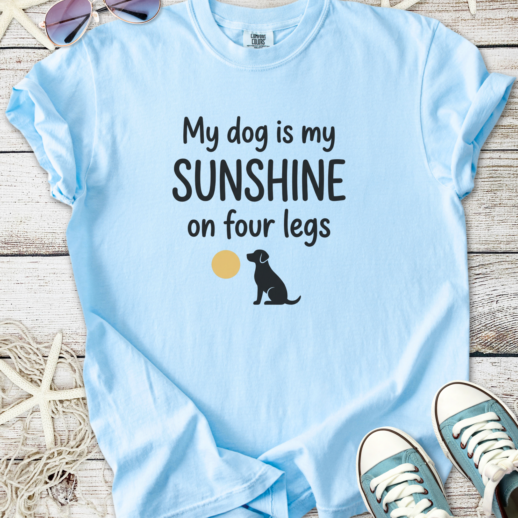 Light blue t-shirt with 'My dog is my sunshine on four legs' graphic and black dog illustration.