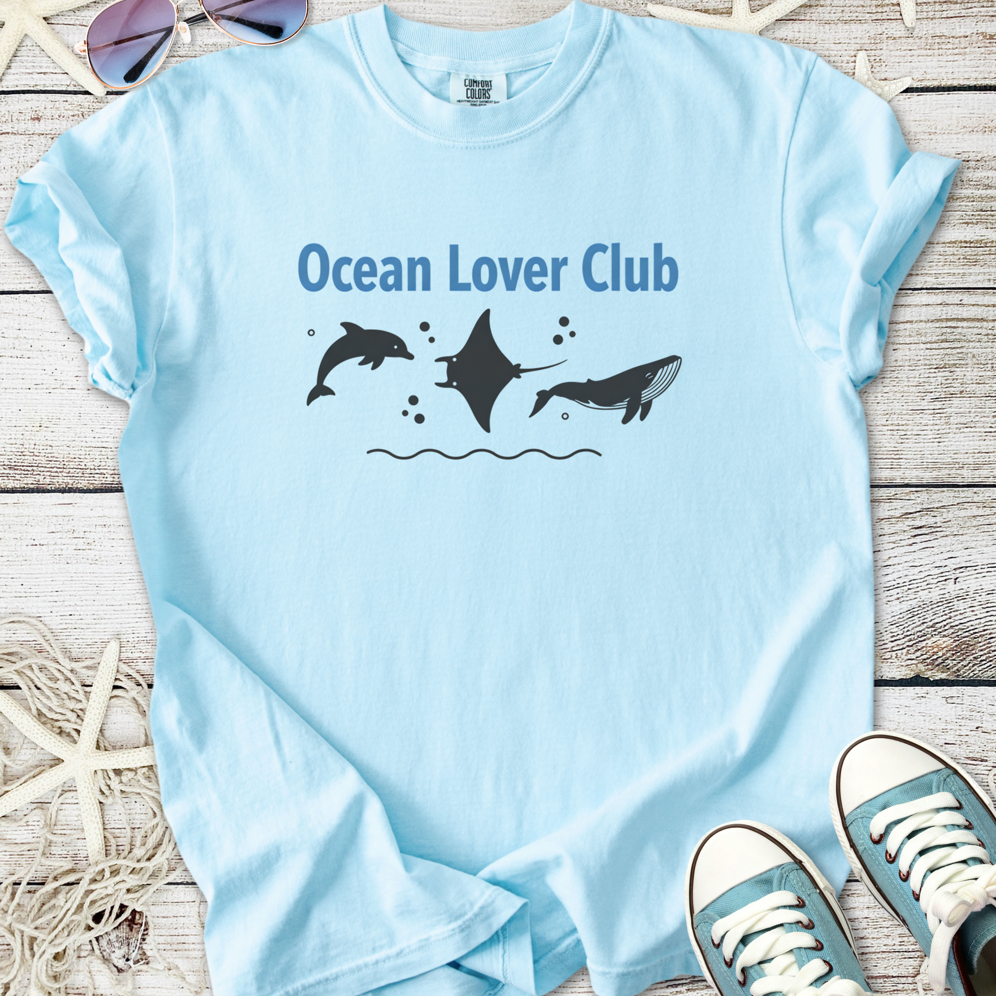 Light blue t-shirt featuring 'Ocean Lover Club' with marine animal graphics, perfect for ocean enthusiasts.