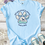 Light blue graphic t-shirt featuring a dog paw design with waves and sun, perfect for dog lovers.