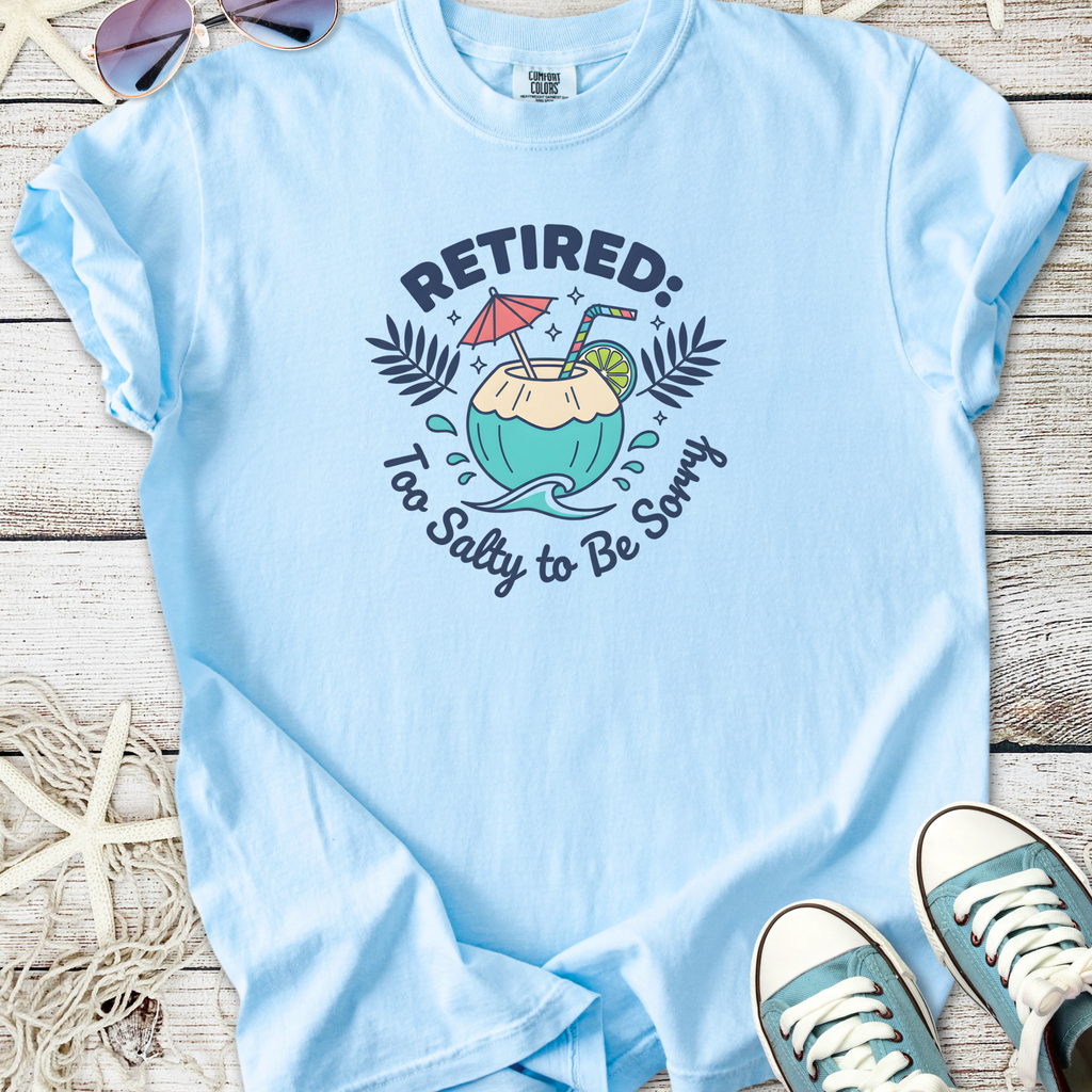 Light blue t-shirt with 'Retired: Too Salty to Be Sorry' graphic, perfect for beach lovers and retirees.