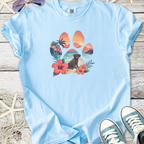 Light blue t-shirt featuring a colorful paw print with tropical beach design and a Labrador dog illustration.