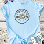 Light blue t-shirt with 'Coffee, Waves, Repeat' graphic and palm trees, perfect for beach lovers.