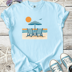 Light blue t-shirt featuring beach chairs, an umbrella, and sun graphic, perfect for summer outings.