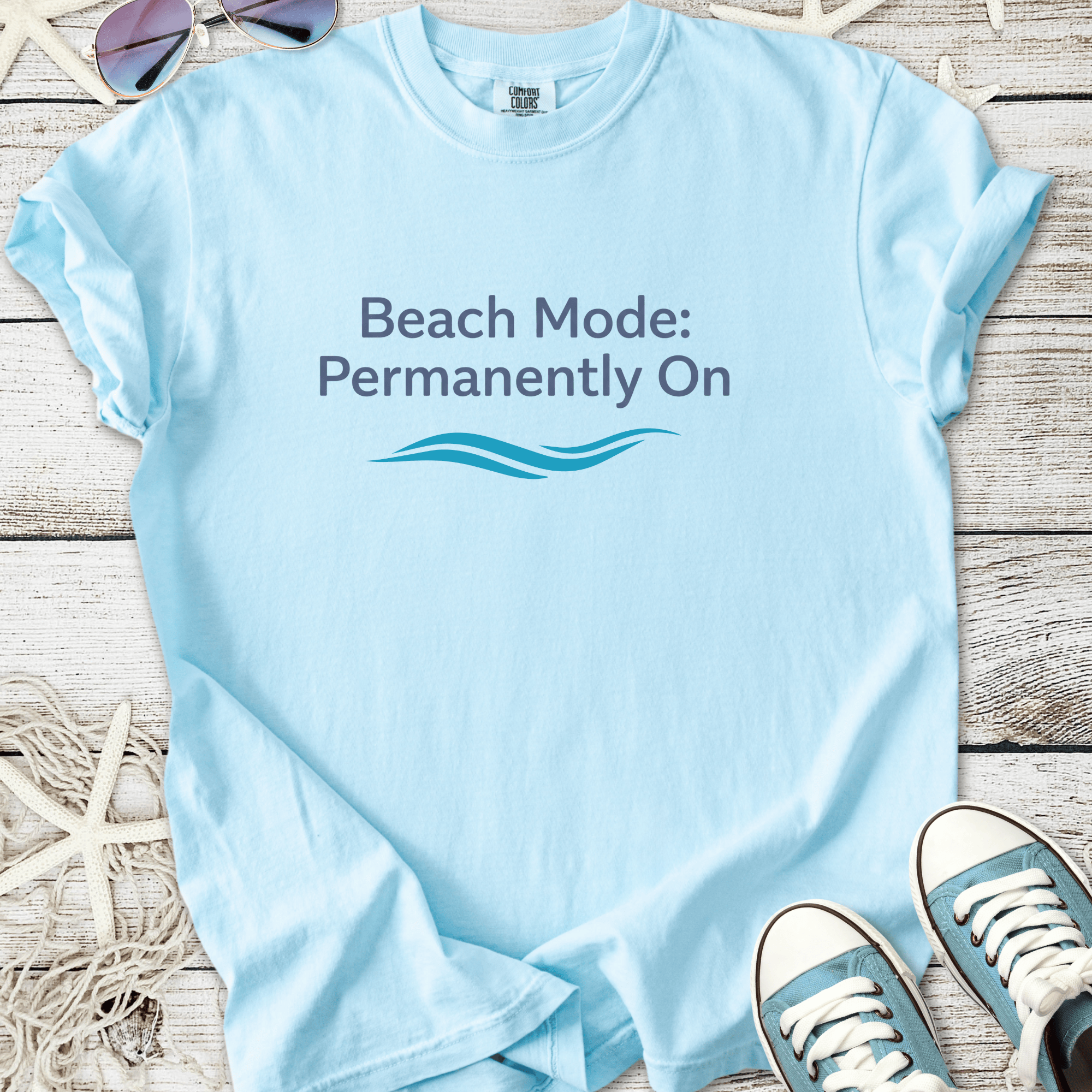 Light blue t-shirt with 'Beach Mode: Permanently On' graphic, perfect for summer vibes.