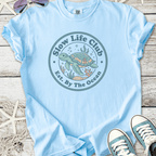 Light blue t-shirt with 'Slow Life Club' sea turtle graphic, perfect for ocean lovers.