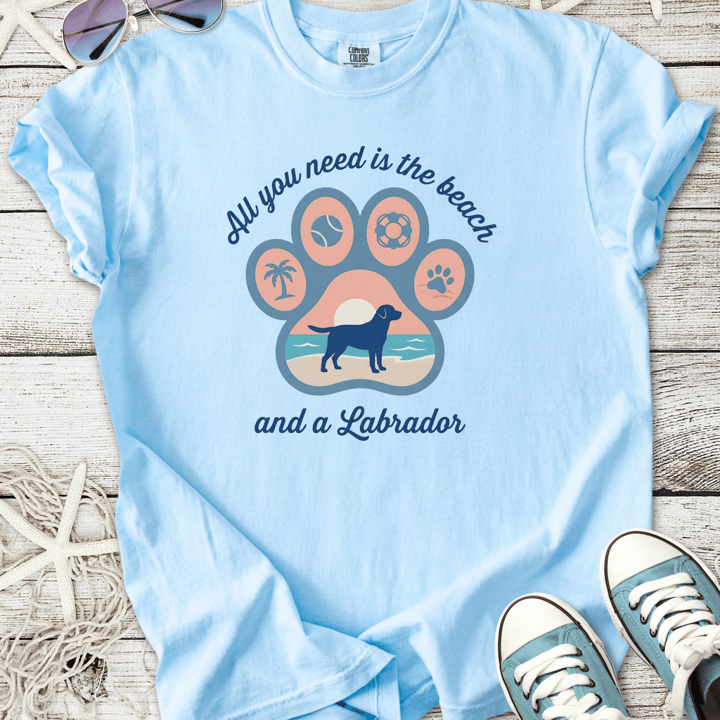 Light blue t-shirt featuring a Labrador and beach-themed graphic, made of soft cotton material.
