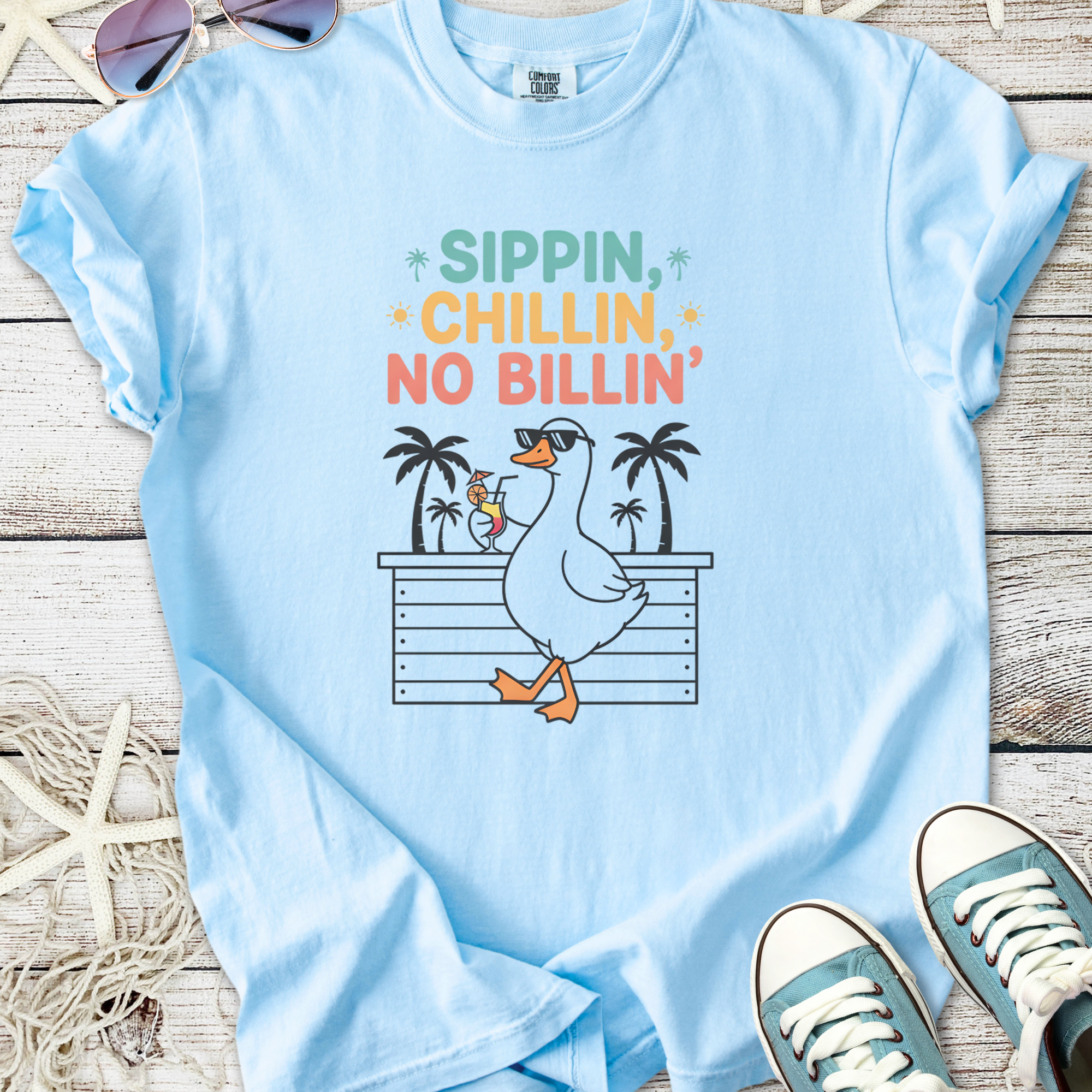 Light blue t-shirt featuring a fun duck graphic with the text 'Sippin, chillin, no billin'.