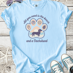 Light blue t-shirt featuring a dachshund graphic and beach-themed design. Perfect for dog lovers.