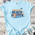 Light blue t-shirt featuring 'Professional Beach Hopper' graphic with flip-flops, ideal for beach lovers.