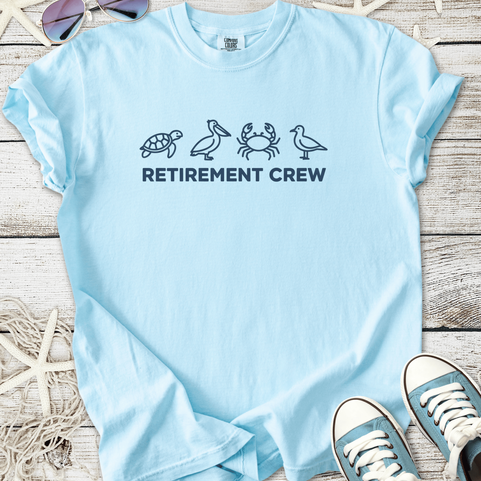 Light blue t-shirt with 'Retirement Crew' and animal graphics, perfect for relaxed retired lifestyle.
