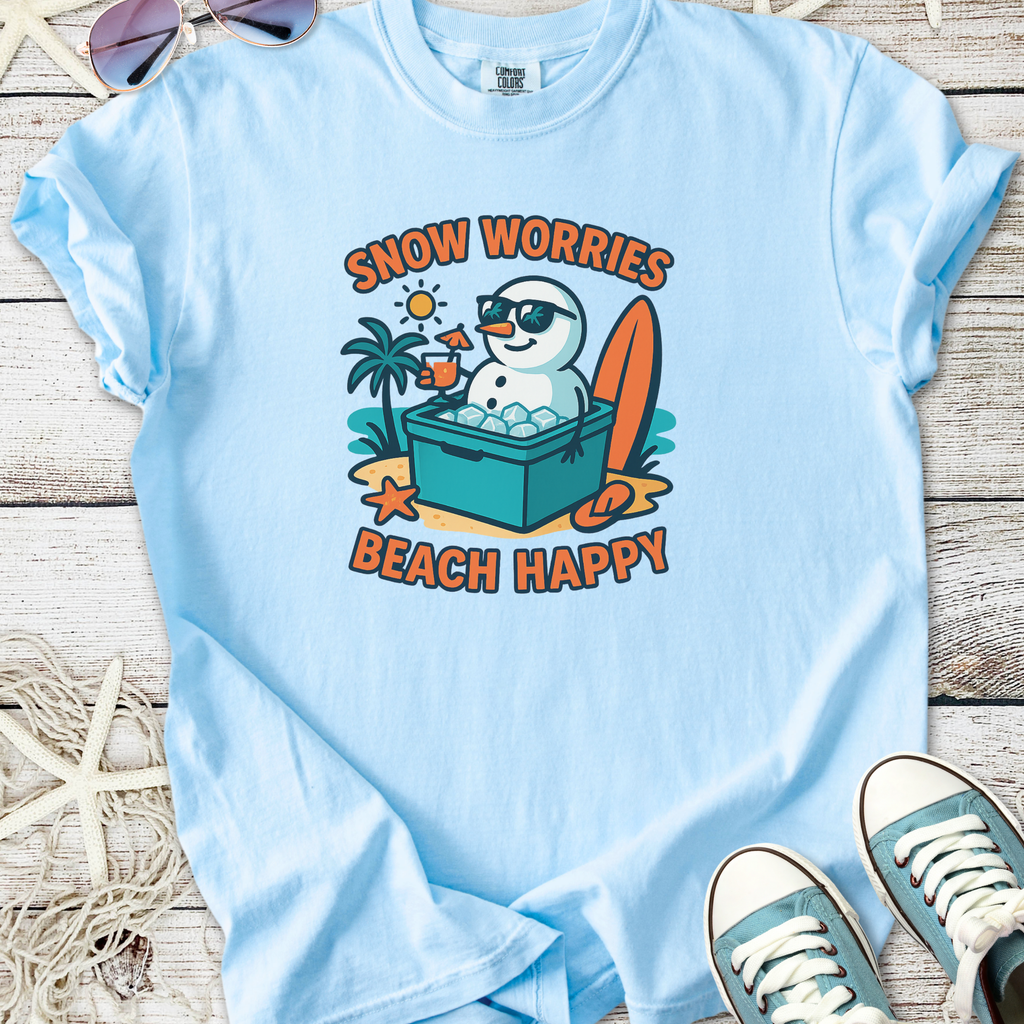 Light blue t-shirt featuring a cartoon snowman in sunglasses, with 'Snow Worries Beach Happy' text, perfect for summer.