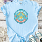 Light blue cotton t-shirt featuring 'Vitamin Sea Daily' graphic with beach design and vibrant colors.