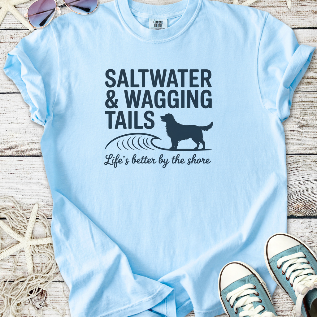 Light blue t-shirt with 'Saltwater & Wagging Tails' print, perfect for dog lovers and beach enthusiasts.