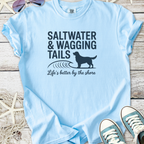 Light blue t-shirt with 'Saltwater & Wagging Tails' print, perfect for dog lovers and beach enthusiasts.