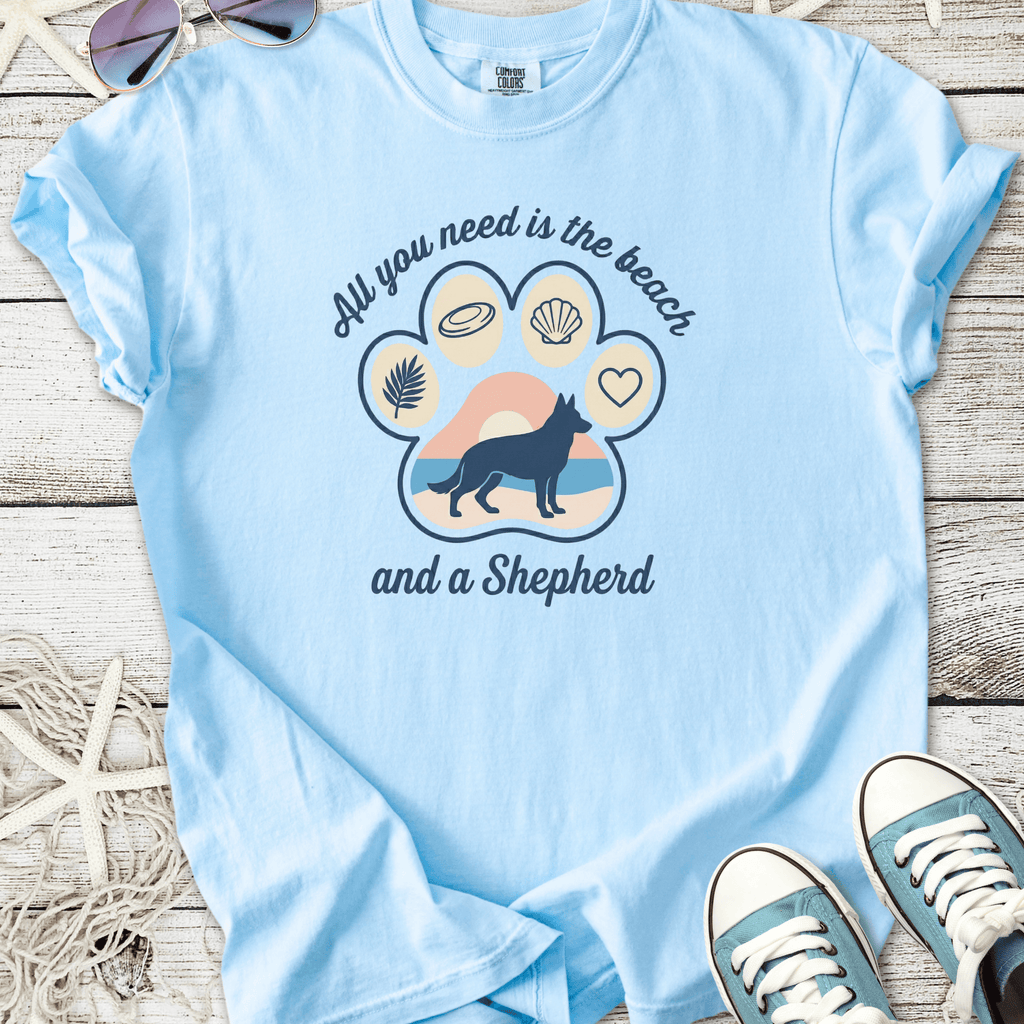 Light blue t-shirt with graphic design featuring a German Shepherd and beach theme text.