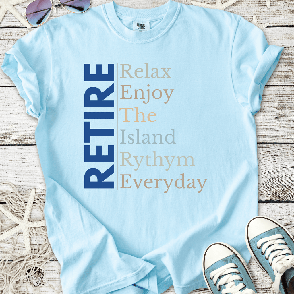 Light blue t-shirt with 'RETIRE' graphic, perfect for relaxed, casual beachwear.