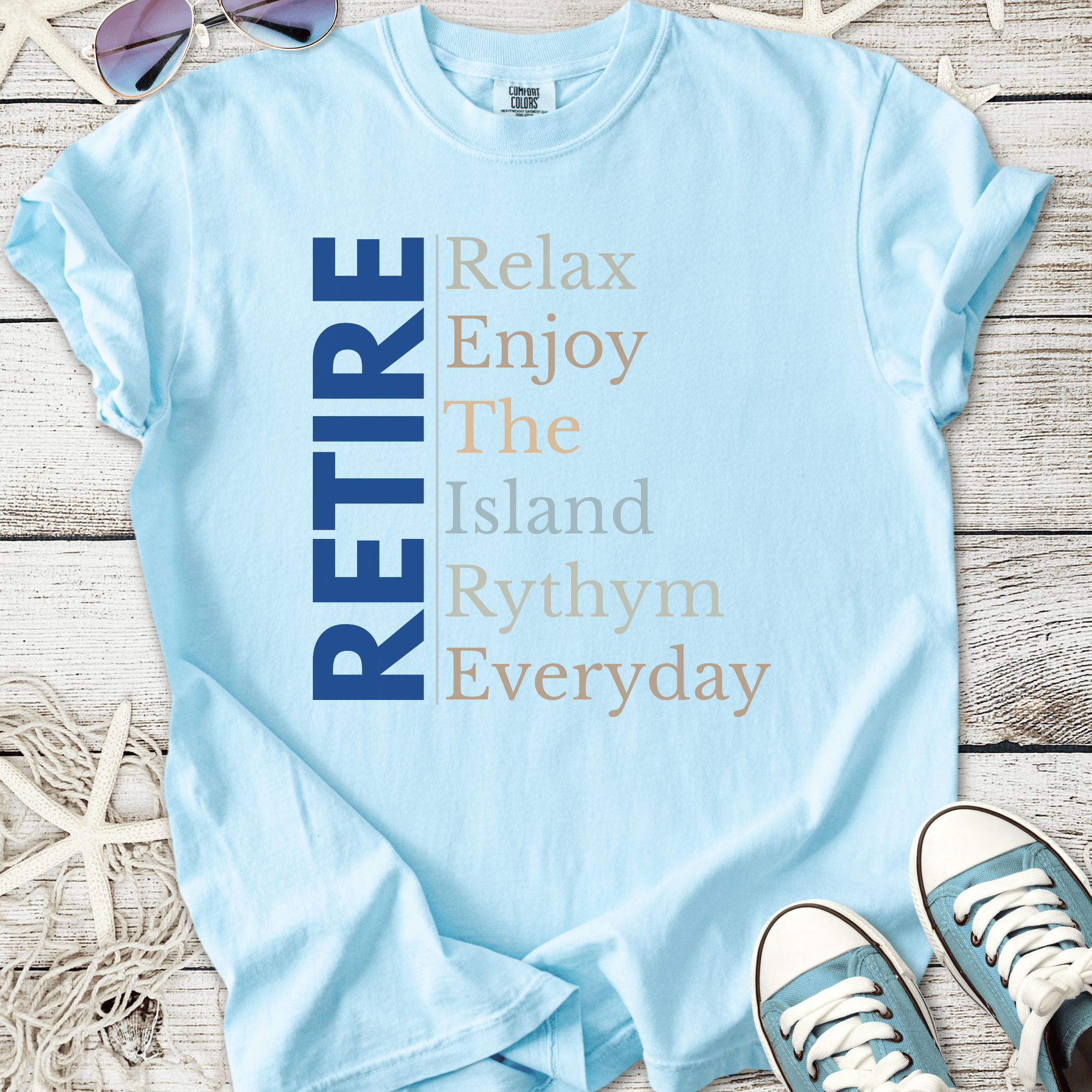 Light blue t-shirt with 'RETIRE' graphic, perfect for relaxed, casual beachwear.