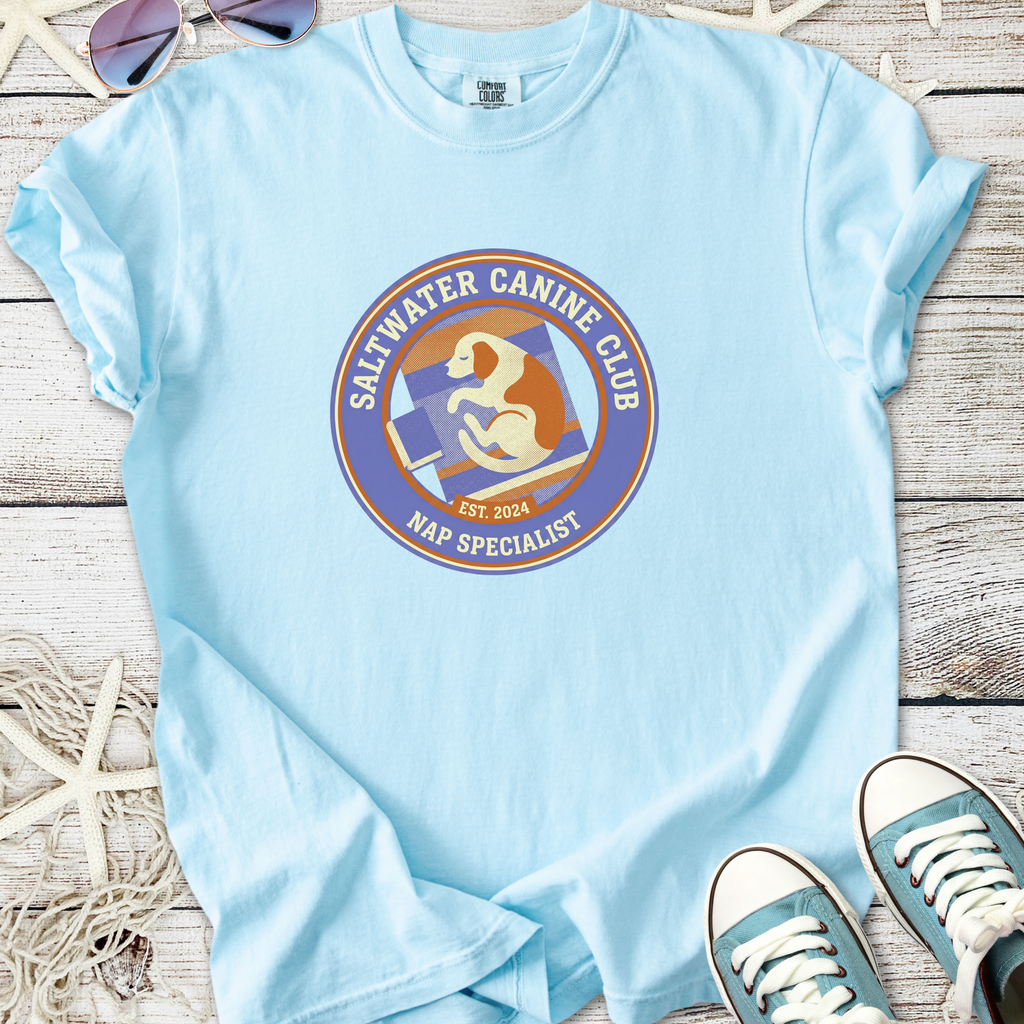 Light blue t-shirt featuring 'Saltwater Canine Club Nap Specialist' graphic, perfect for dog lovers.