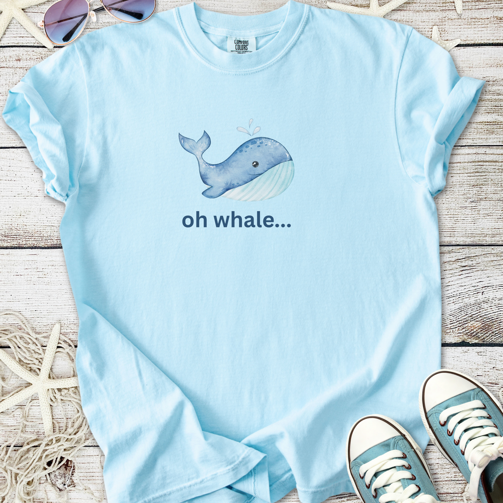 Light blue t-shirt featuring a playful whale graphic and the text 'oh whale...' in a casual style.
