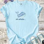 Light blue t-shirt featuring a playful whale graphic and the text 'oh whale...' in a casual style.