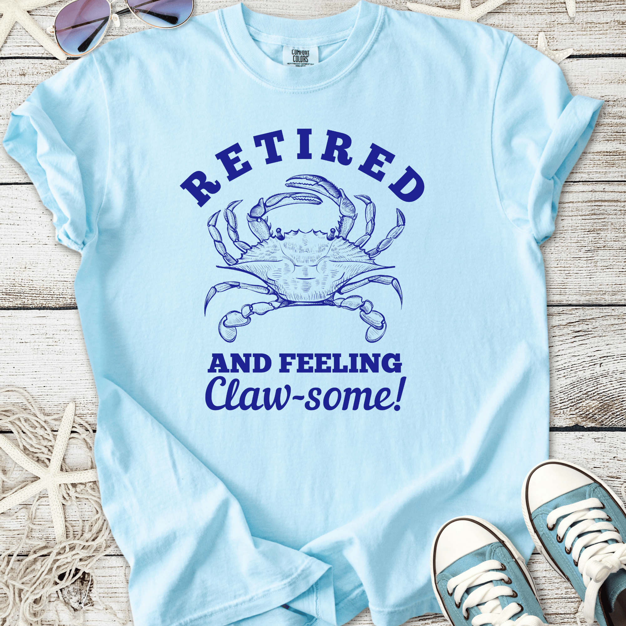 Light blue t-shirt featuring a crab graphic and the text 'Retired and Feeling Claw-some!'