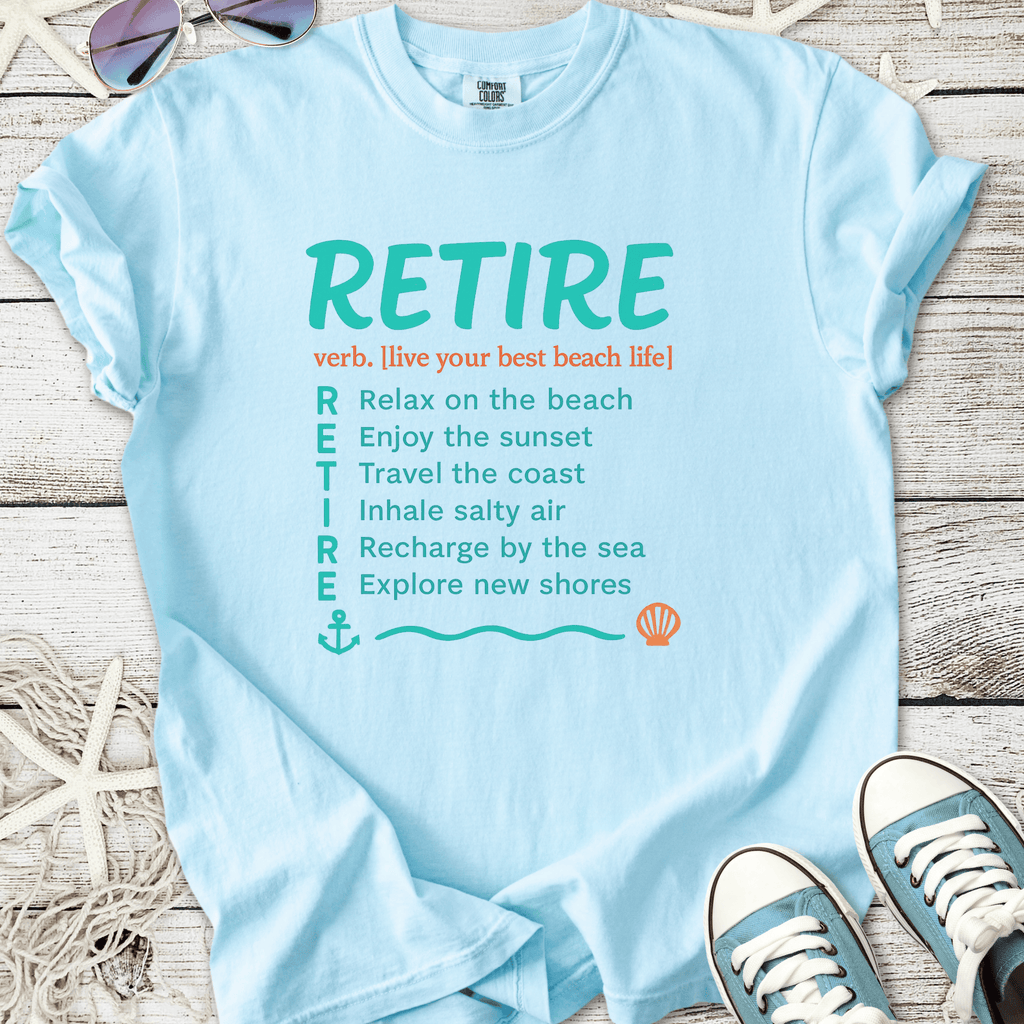 Light blue t-shirt with 'RETIRE' graphic, featuring beach life activities and relaxation tips.